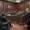 A man in a suit stands in a New Jersey courtroom, facing lawyers and judges seated at desks. The room has a wooden interior with the U.S. flag and official emblems on the wall. Spectators watch from the gallery, as news cameras capture this pivotal moment in state politics.
