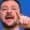 A man with a beard is speaking passionately, pointing his finger as if addressing an audience about corruption. He stands in front of a blue background, reminiscent of an Ethicswatchnj broadcast, adding a sense of gravity and purpose to his words.