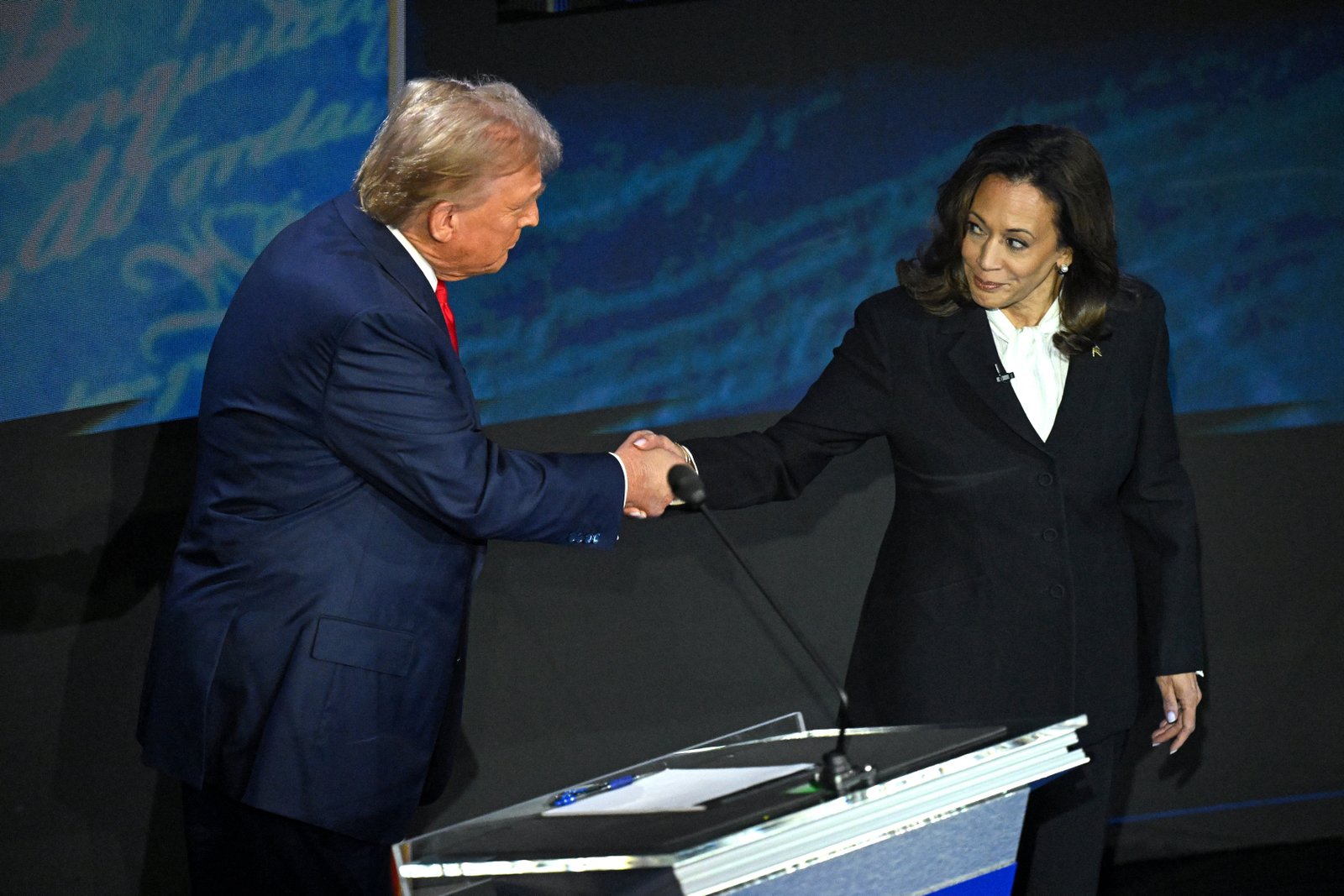 US Vice President and Democratic presidential candidate Kamala Harris (R) shakes hands with former US President and Republican presidential candidate Donald Trump during a presidential debate at the National Constitution Center in Philadelphia, Pennsylvania, on September 10, 2024