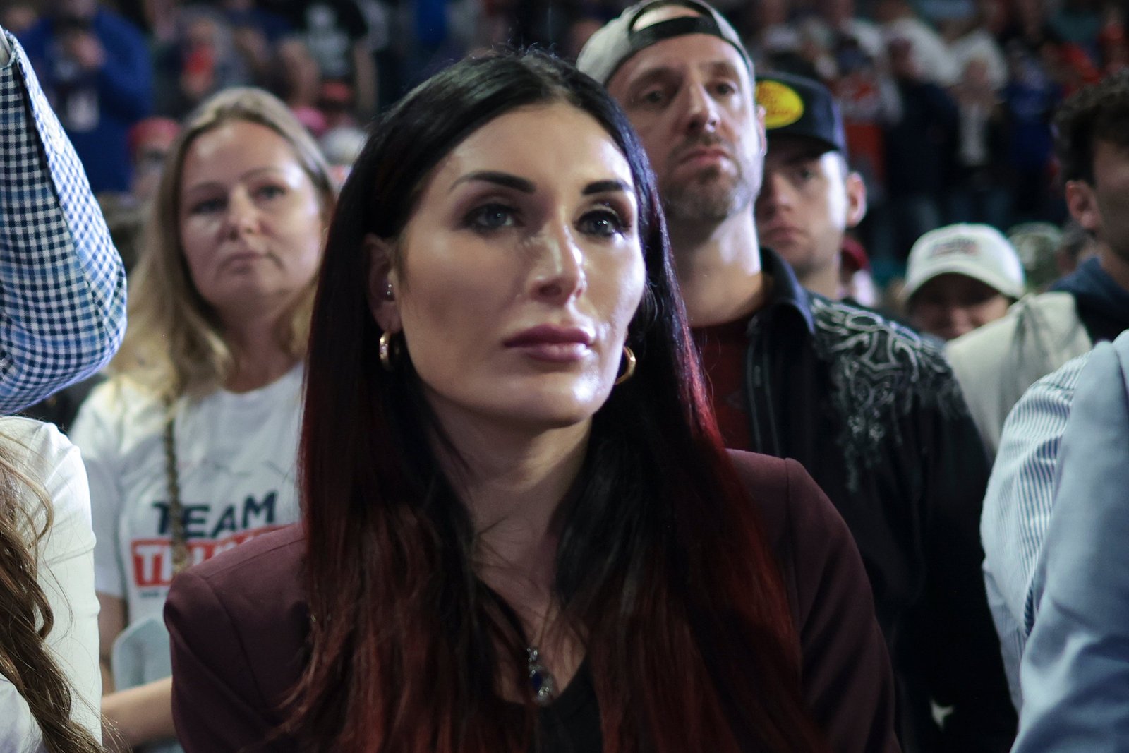 Far-right activist Laura Loomer listens as Republican presidential candidate and former President Donald Trump speaks during a Get Out The Vote rally at Coastal Carolina University on February 10