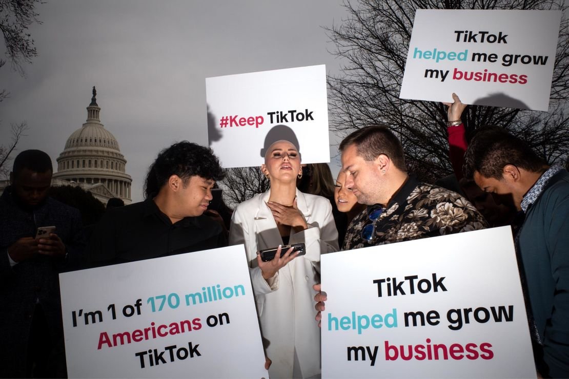Supporters of TikTok watch a feed of the House vote as they gather outside the US Capitol in Washington, DC, in March 2024.