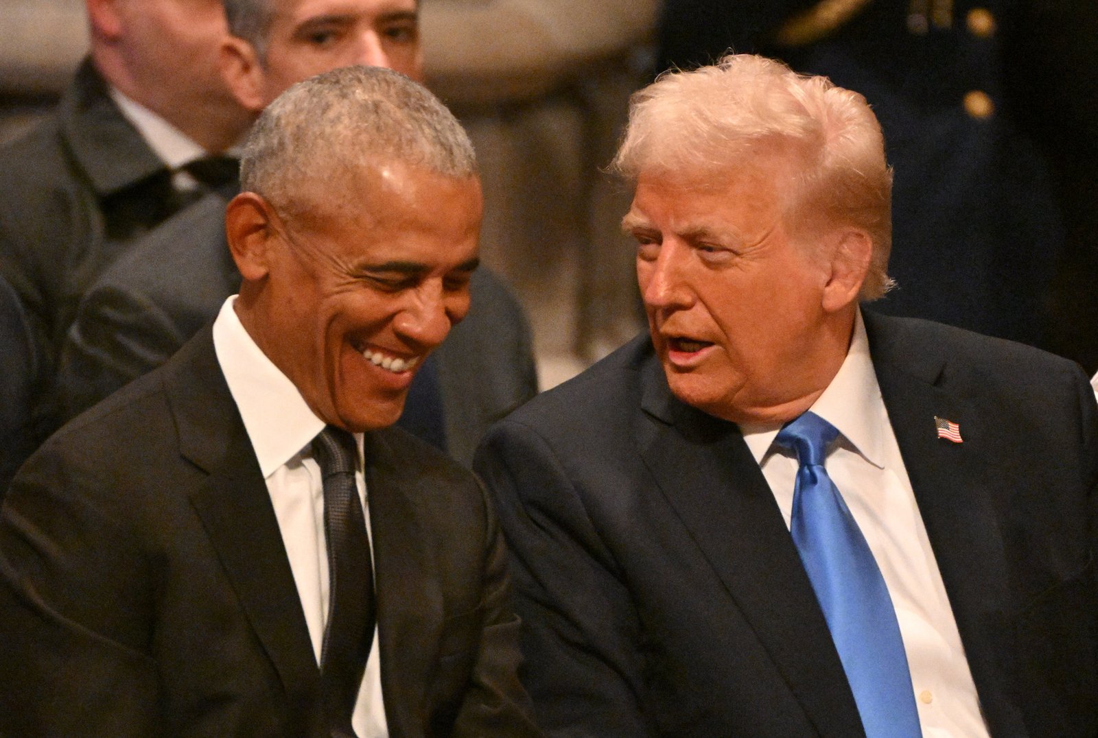 Former President Barack Obama speaks with President-elect Donald Trump before the State Funeral Service for former President Jimmy Carter at the Washington National Cathedral in Washington, DC, on January 9, 2025.