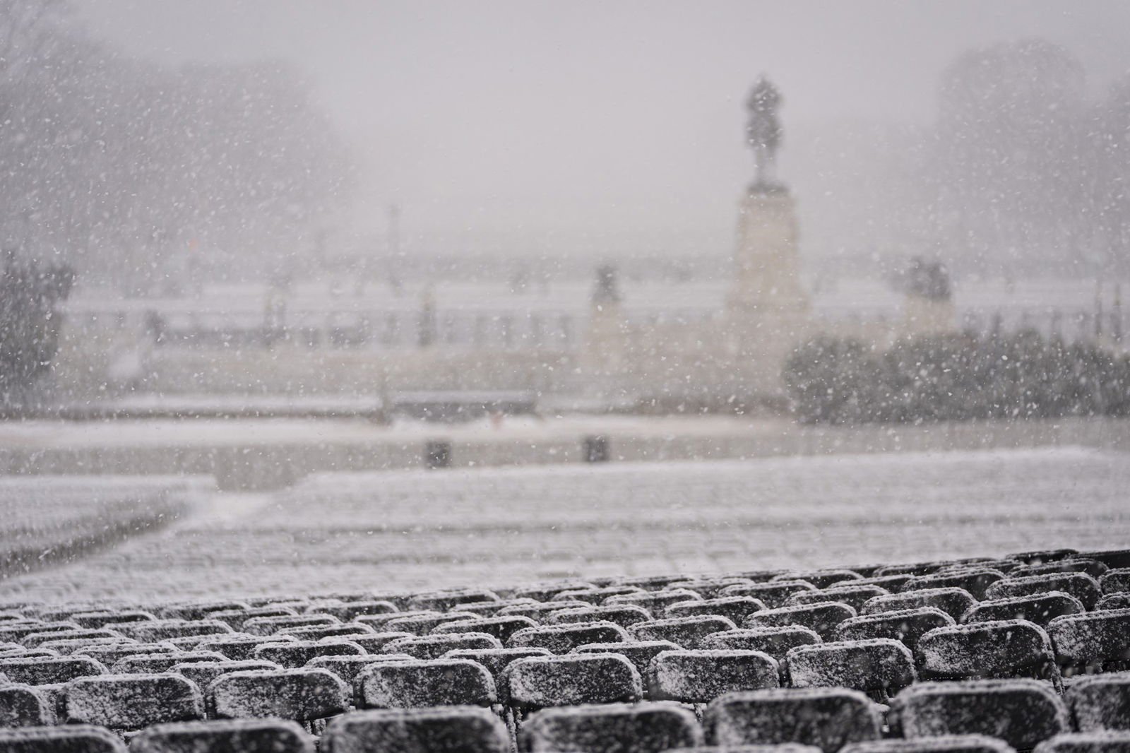 Rows of chairs are covered in icicles and snow
